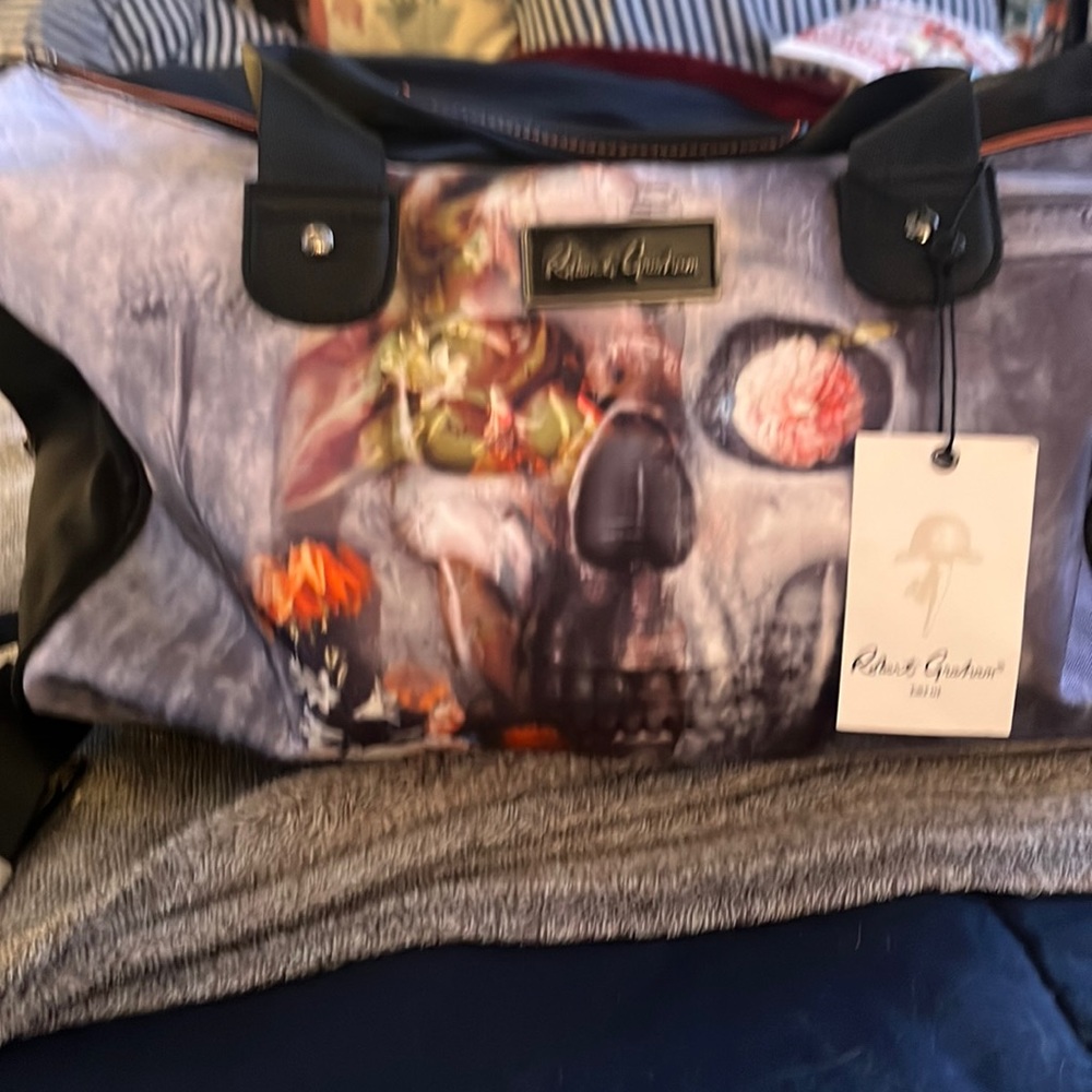 This matching Robert Graham duffel bag: travel shave kit AND matching umbrella..